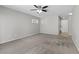 Large carpeted living room features natural light from windows and ceiling fan at 8453 Cheerful Brook Ave, Las Vegas, NV 89143