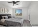Virtually staged bedroom featuring large windows, a ceiling fan, and an exterior door at 913 Duckhorn Ct # 201, Las Vegas, NV 89144