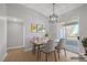 Virtually staged dining room featuring modern light fixture, hardwood floors, and sliding glass doors at 913 Duckhorn Ct # 201, Las Vegas, NV 89144