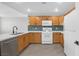 Bright kitchen features white countertops, wood cabinets, stainless steel dishwasher, and modern fixtures at 913 Duckhorn Ct # 201, Las Vegas, NV 89144