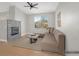Virtually staged living room with a gray brick fireplace, ceiling fan, and hardwood floors at 913 Duckhorn Ct # 201, Las Vegas, NV 89144