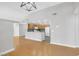 Bright open-concept living space featuring hardwood floors and direct access to a modern kitchen with white appliances at 913 Duckhorn Ct # 201, Las Vegas, NV 89144