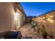 Paver patio with seating, string lights, and sliding glass door access to the home's interior at 916 Belleforte Ln, Las Vegas, NV 89138