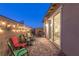 Back patio with pavers, string lights, comfortable seating, and a sliding door at 916 Belleforte Ln, Las Vegas, NV 89138