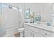 Bright bathroom with white cabinetry, a bathtub-shower, and stylish decor accents at 916 Belleforte Ln, Las Vegas, NV 89138