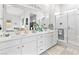 Bright bathroom features double sinks, white cabinets, a glass shower, and decorative mirror at 916 Belleforte Ln, Las Vegas, NV 89138