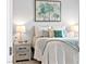 Well-lit bedroom with a decorative painting, nightstand and decorative pillows at 916 Belleforte Ln, Las Vegas, NV 89138