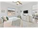 Bright primary bedroom with ceiling fan, television and stylish furniture at 916 Belleforte Ln, Las Vegas, NV 89138