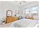 Well-lit bedroom featuring a large dresser, a decorative mirror, and a scenic view from the windows at 916 Belleforte Ln, Las Vegas, NV 89138