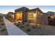 Home exterior featuring a stone accent wall, desert landscaping, and a paved walkway at 916 Belleforte Ln, Las Vegas, NV 89138