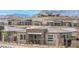 Exterior of a single-story home showcasing stone accents, landscaping, and mountain views at 916 Belleforte Ln, Las Vegas, NV 89138