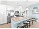 Modern kitchen with a breakfast bar, pendant lighting, stainless appliances, and quartz countertops at 916 Belleforte Ln, Las Vegas, NV 89138