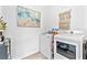 Laundry room featuring a washer and dryer, adjacent to a decorative painting and woven wall art at 916 Belleforte Ln, Las Vegas, NV 89138