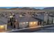 Rear view of a gray home with garage, small trees, and fenced in backyard in a residential area at 916 Belleforte Ln, Las Vegas, NV 89138