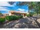 Charming backyard with desert landscaping, covered patio and multiple windows for ample light at 9513 Yucca Blossom Dr, Las Vegas, NV 89134