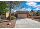 Charming single-story home with a well-manicured front yard and an attached two-car garage at 9513 Yucca Blossom Dr, Las Vegas, NV 89134