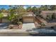 Charming home featuring a two-car garage, desert landscaping, and a well-maintained driveway and front yard at 9513 Yucca Blossom Dr, Las Vegas, NV 89134
