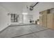Spacious garage featuring laundry area, storage cabinets, and epoxy-sealed flooring at 9513 Yucca Blossom Dr, Las Vegas, NV 89134