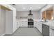 Updated kitchen features white cabinets, stainless steel appliances, and designer tile flooring at 9513 Yucca Blossom Dr, Las Vegas, NV 89134