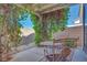 Private back patio area with mature landscaping, stone pavers, and decorative seating at 953 Wagner Valley St, Henderson, NV 89052