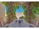 Inviting outdoor patio with decorative trellis and seating; stone landscaping at 953 Wagner Valley St, Henderson, NV 89052