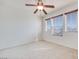 Bright bedroom with a ceiling fan and natural light from three large windows at 953 Wagner Valley St, Henderson, NV 89052