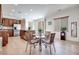 Open floor plan with dining area, kitchen island, stainless steel appliances, and plenty of cabinet space at 953 Wagner Valley St, Henderson, NV 89052