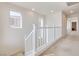 Bright hallway featuring carpeted floors, white walls, and natural light from windows at 953 Wagner Valley St, Henderson, NV 89052