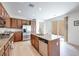 Open kitchen with stainless appliances, a center island, and access to the backyard at 953 Wagner Valley St, Henderson, NV 89052