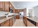 Spacious kitchen features stainless steel appliances, wood cabinets, granite countertops, and a kitchen island at 953 Wagner Valley St, Henderson, NV 89052