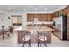 Spacious kitchen with stainless steel appliances, island with seating, and wooden cabinetry at 953 Wagner Valley St, Henderson, NV 89052