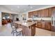 Open kitchen featuring a large island, stainless steel appliances, and wood cabinets at 953 Wagner Valley St, Henderson, NV 89052