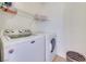 Clean laundry room with washer, dryer, and shelving for storage at 953 Wagner Valley St, Henderson, NV 89052