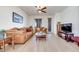 Cozy living room with natural lighting, ceiling fan, hardwood flooring, and neutral paint at 953 Wagner Valley St, Henderson, NV 89052