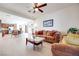 Bright and open living room with ceiling fan, hardwood floors, and view into the kitchen at 953 Wagner Valley St, Henderson, NV 89052
