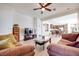 Open living room with view of kitchen and dining area, ceiling fan, and hardwood flooring at 953 Wagner Valley St, Henderson, NV 89052