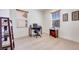 Well-lit home office with hardwood floors, two windows, and a functional workspace at 953 Wagner Valley St, Henderson, NV 89052