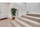 Entryway featuring staircase with carpeted steps, neutral paint, and light hardwood flooring at 953 Wagner Valley St, Henderson, NV 89052