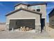 Modern two-story home with gray stucco and a spacious two-car garage featuring stone accents at 9548 Hinson St, Las Vegas, NV 89139