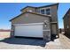 Two-story home with a neutral color palette, a two car garage, and a well-kept front yard at 9548 Hinson St, Las Vegas, NV 89139