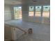 Bright, unfinished living room featuring sliding glass doors and multiple windows, awaiting customization at 9548 Hinson St, Las Vegas, NV 89139