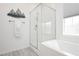 Serene bathroom featuring a bathtub with a clear glass shower enclosure and a stylish decorative accent that adds charm to the space at 965 Nevada State Dr # 35101, Henderson, NV 89002