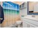 Well-lit bathroom with coastal decor, a beach themed shower curtain, and a stylish vanity at 965 Nevada State Dr # 35101, Henderson, NV 89002