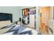 Stylish bedroom with built-in closet, mirrored nightstand, and blue accents at 965 Nevada State Dr # 35101, Henderson, NV 89002