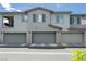 Exterior of a modern townhome featuring multiple units, each with a private garage and contemporary architectural details at 965 Nevada State Dr # 35101, Henderson, NV 89002