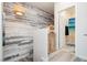 Bright hallway featuring a decorative accent wall and a charming wooden cabinet with a decorative wicker light fixture overhead at 965 Nevada State Dr # 35101, Henderson, NV 89002