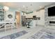 Bright kitchen features white cabinets, stainless steel appliances, large island with seating, and decorative blue pendant lights at 965 Nevada State Dr # 35101, Henderson, NV 89002