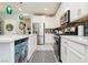 Bright kitchen features an island with sink, stainless steel appliances, white cabinets, and modern backsplash at 965 Nevada State Dr # 35101, Henderson, NV 89002