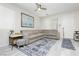 Cozy living room features a plush sectional sofa, large windows with blinds, and stylish decor on light-colored tile flooring at 965 Nevada State Dr # 35101, Henderson, NV 89002