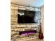 Comfortable living room with a decorative fireplace and wooden accent wall perfect for a modern aesthetic at 965 Nevada State Dr # 35101, Henderson, NV 89002